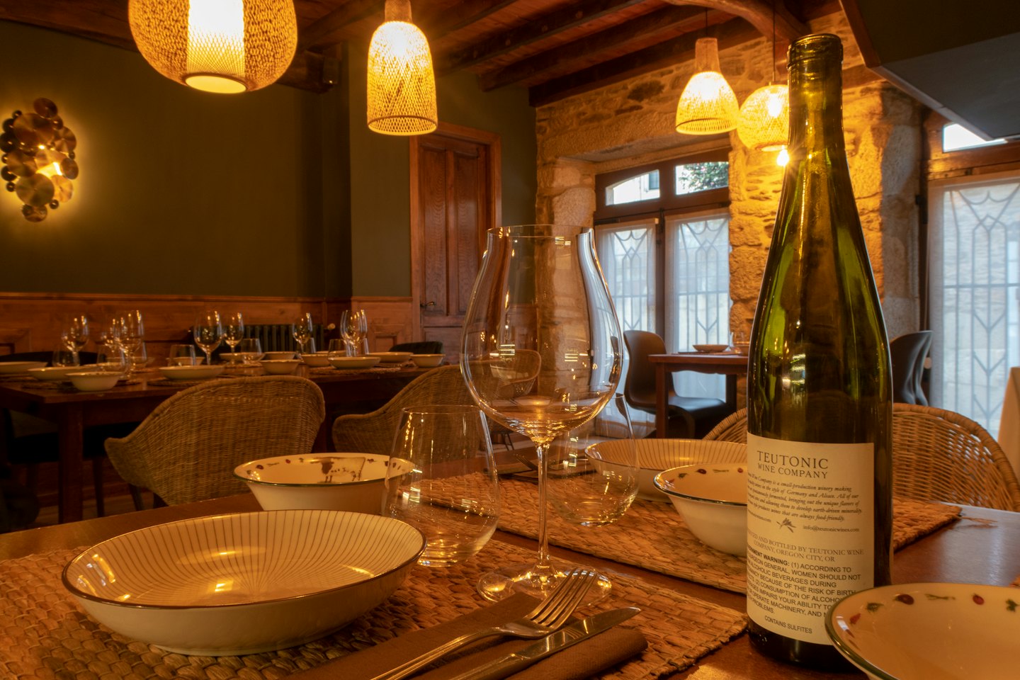 Dining table set for a meal in a rustic restaurant.