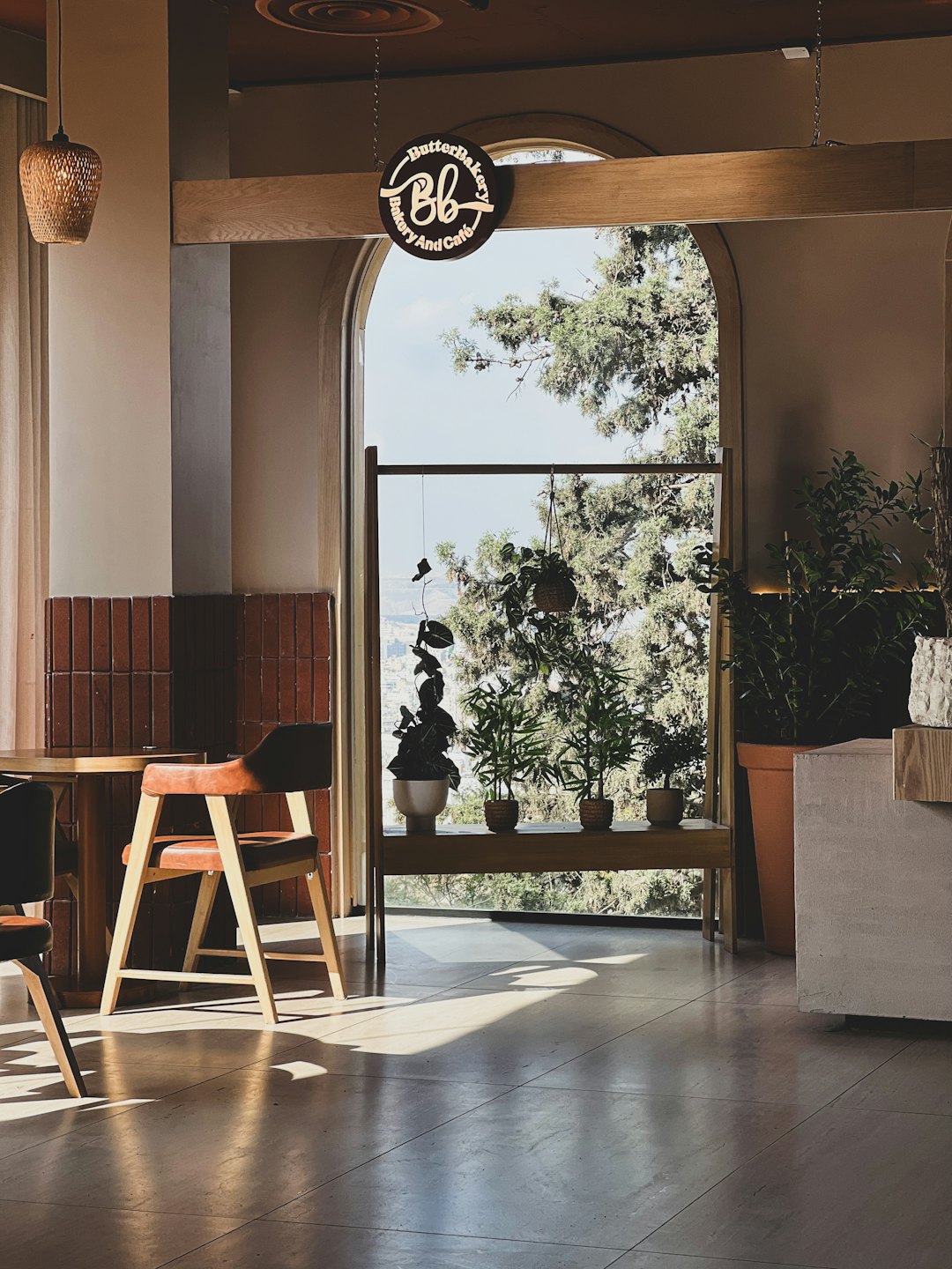 Brown leather cafe chairs and a wooden table sit indoors.